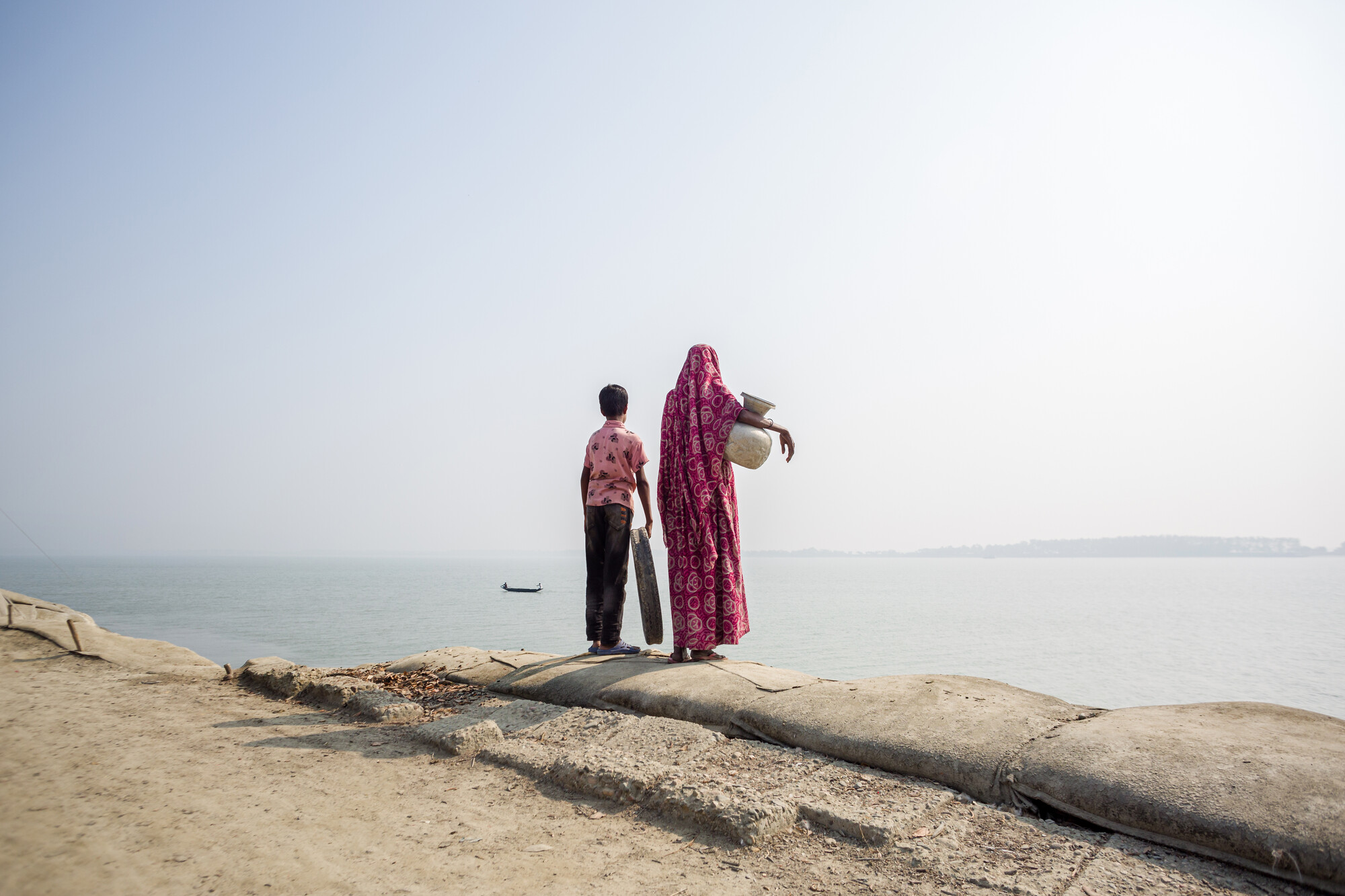 A mother and her child fetch water in the coastal belt of Bangladesh. Photo: Jahangir Alam/Oxfam