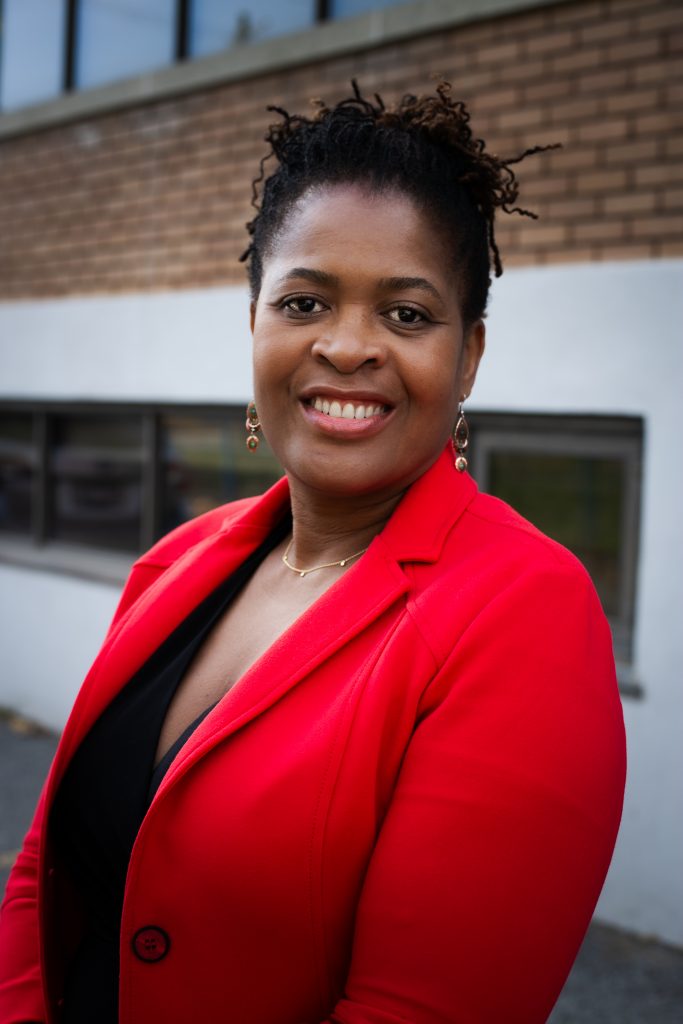 photo of a black woman wearing a red blazer